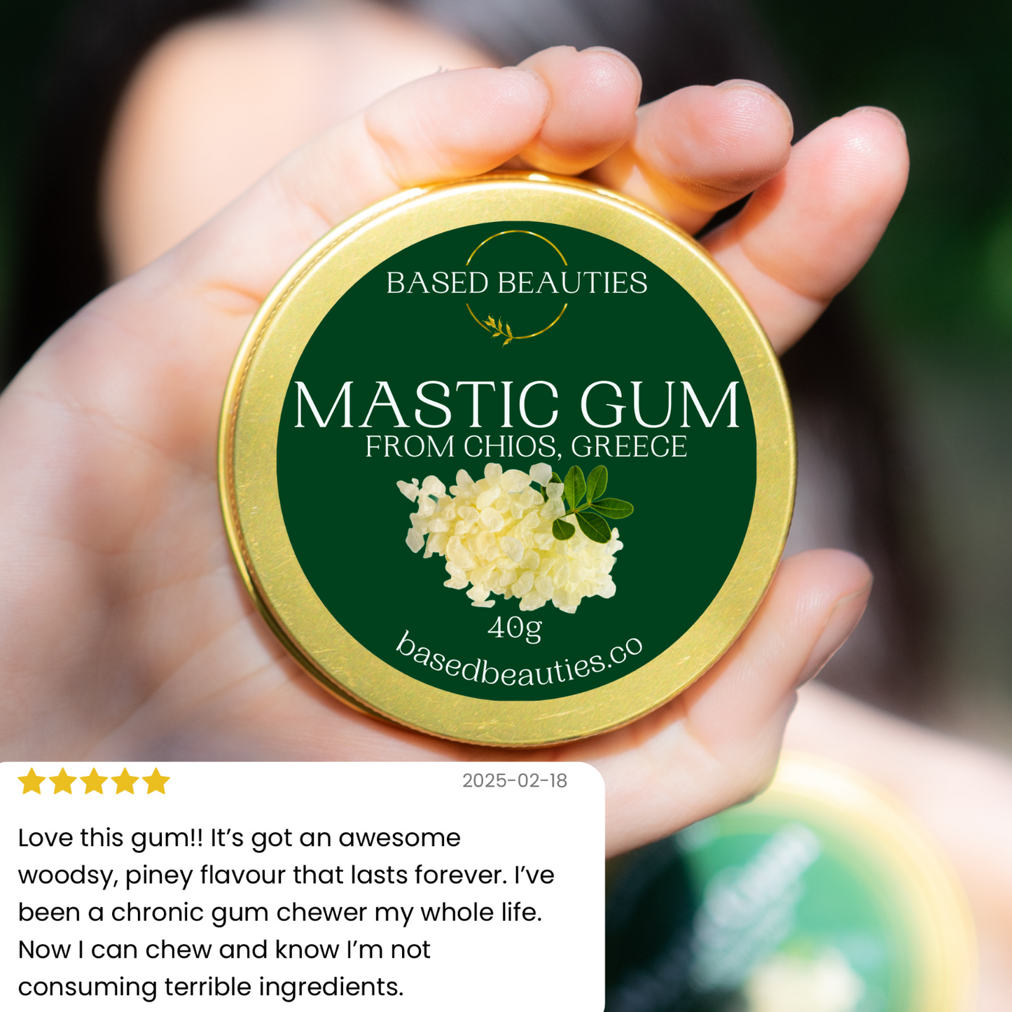 Hand holding a container of mastic gum with a green label, featuring the brand 'Based Beauties'.